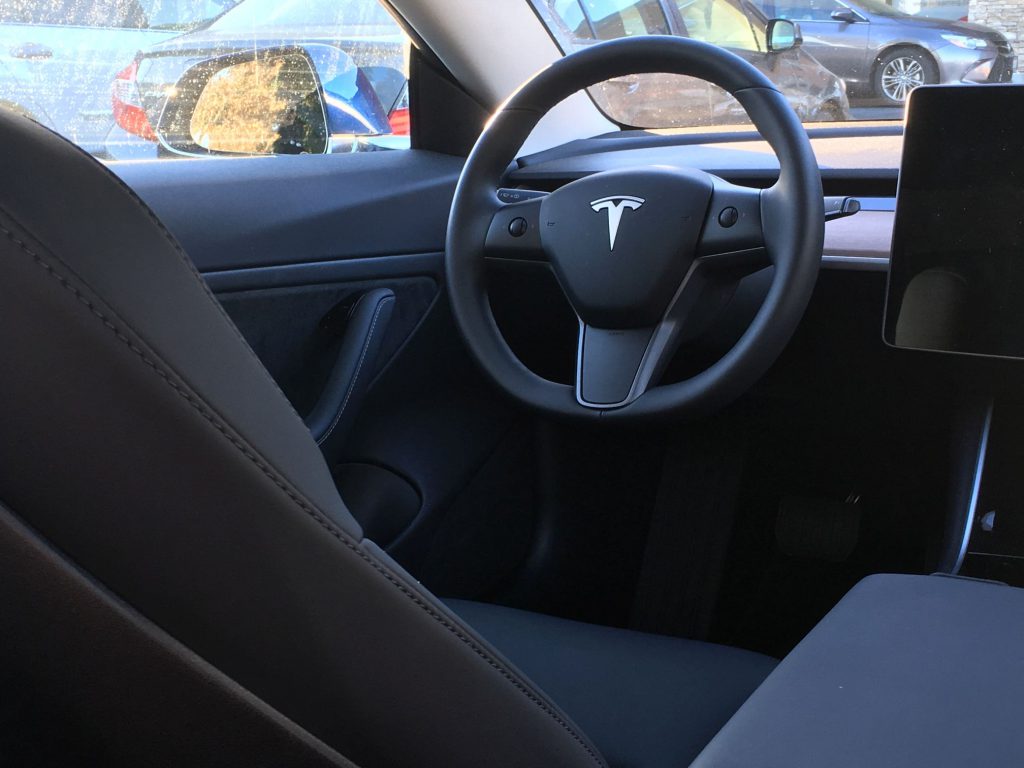 A US$57,000 car with only 'faux leather' seats and 'faux wood' dashboard??? Tesla Model 3 interior - driver seat perspective