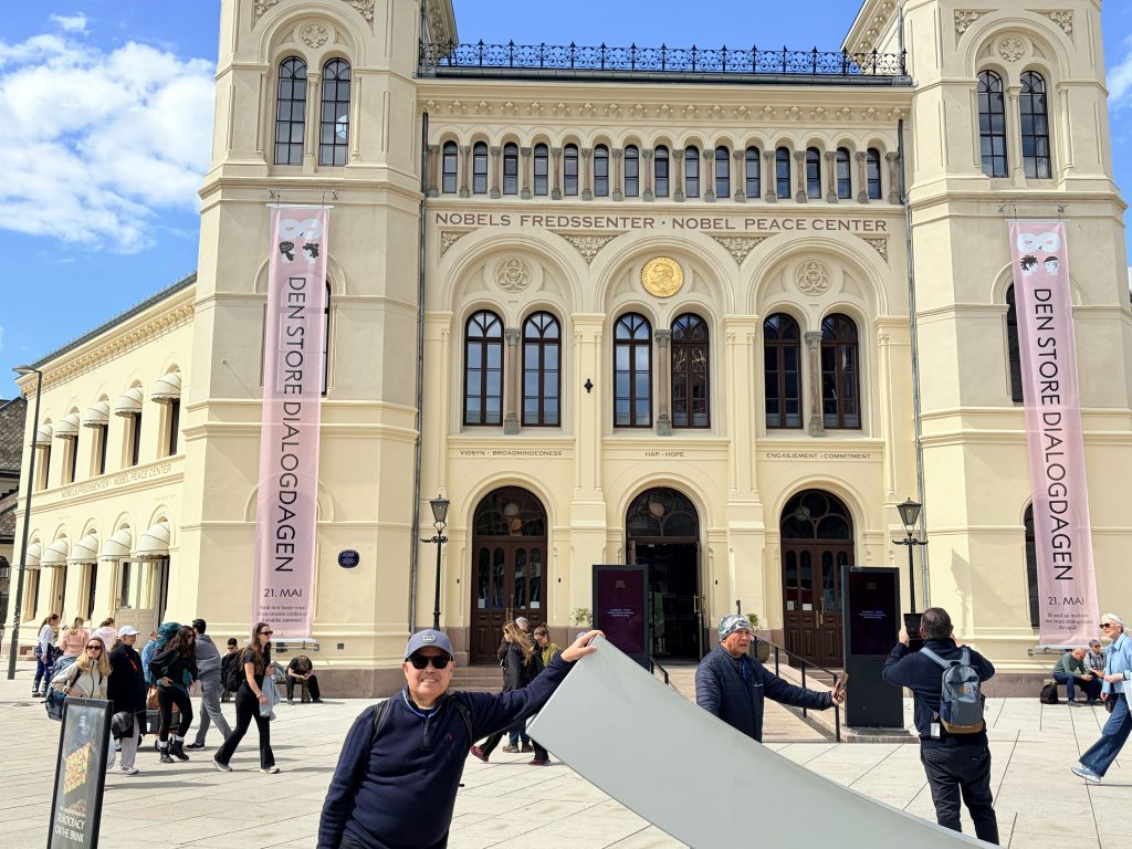 At the facade of the Nobel Peace Center building in Oslo.  While the center showcases the history of the much-coveted award, the actual awarding ceremony takes place inside Oslo City Hall.